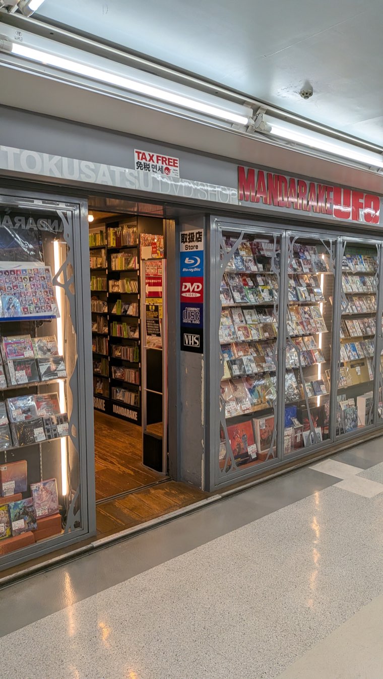 Ladenfront von Mandarake UFO mit einem Schild mit TOKUSATSU und MANDARAKE UFO sowie Vitrinen mit den Aufschriften Blu-ray, DVD und VHS